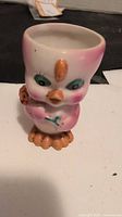 Front view of one pink chick egg cup
