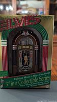 Front of box showing Elvis jukebox ornament details, limited edition notice, song titles