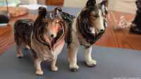Front view of both ceramic Collie figurines on tabletop