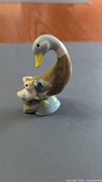 Front angled view of ceramic mother duck and duckling figurine
