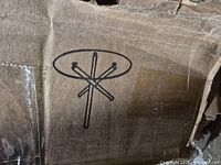 Carton corner showing printed icon of table base