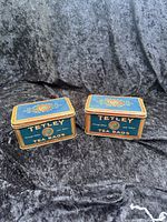Front view of both Tetley Tea Bags tins