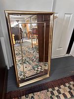 Full view of brass framed rectangular mirror showing frame and interior brass trim