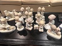Group shot of all Precious Moments figurines on table