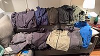 All ten jackets laid out on couch showing colors and styles