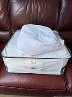 Duvet in clear case labelled GEL-3 with folded mattress protector on top