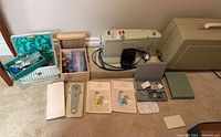 Full lot layout showing sewing machine, manuals, boxes of accessories