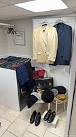 Overall lot view showing suits, ties, briefcase, hats, shoes
