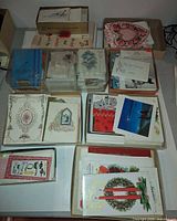 stacked cardboard and plastic boxes filled with vintage greeting cards for various occasions