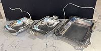 All three silver-plated dishes side by side