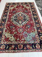 Full view of rug showing field, medallion and borders