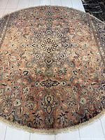 Full view of round Persian rug showing central medallion and overall pattern