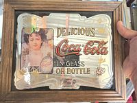 Front view of framed Coca-Cola mirror sign