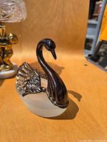 Side view of silver-tone and glass swan sugar cellar