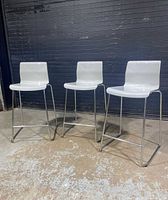 Front view of all three white bar stools