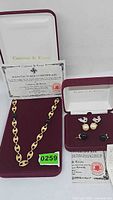 Necklace and earrings in boxes with certificates displayed