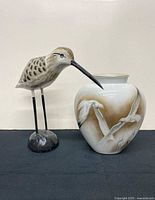 Front view of wooden shorebird and Heinrich seagull vase