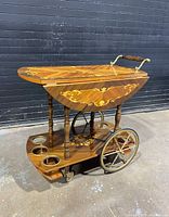 Full view of bar cart with one leaf raised showing inlaid top and wheel design