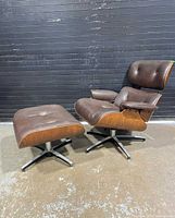 Lounge chair and ottoman front three-quarter view showing overall style and condition