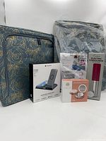 Group shot showing both floral storage bags plus boxed Mophie dock, Halo compact and Rabbit corkscrew