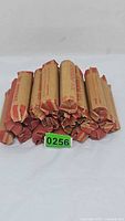 Stacked paper-wrapped penny rolls with green lot tag visible