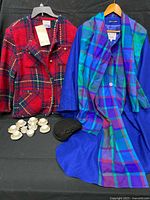 All items laid out: plaid jacket, blue tartan cape coat, black hat, miniature Sandford tea set