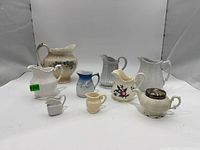 Group shot of all nine vintage creamers