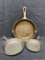 Front view showing three cast iron skillets nested