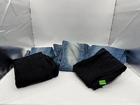 Front view of all seven folded jeans