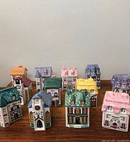 All twelve miniature house-shaped spice jars on tabletop