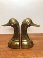Front view of pair of brass duck head bookends