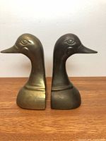 Front view of both brass duck head bookends