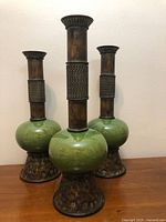 Three matching tall candlestick holders front view