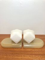 Front view of both onyx bookends on wood surface