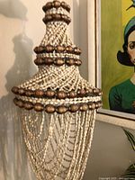 Full view of hanging shell chandelier-style shade