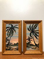 Both framed palm tree paintings front view