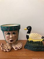 planter pot and duck door stop side by side