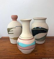 Front view of three vases showing shapes and painted designs