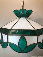 Overall view of hanging lamp showing green and white stained glass shade