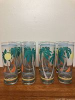 Eight matching tall glasses with tropical design