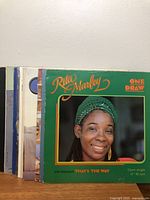 Stack of vinyl LPs with Rita Marley sleeve at front and additional records behind