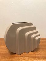 Front view of beige ceramic stepped vase