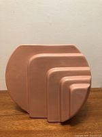 Front view of pink ceramic stepped vase