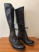 Full view of both Frye boots standing upright