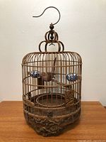 Full view of carved wood birdcage with hook