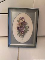 Small oval floral print in silver-tone frame