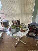 Wide shot of both tables showing all books, magazines, CD, calendar, figurine