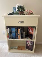 Overall shot of bookshelf showing 12 books and multiple décor items