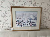 Framed Grandma Moses winter sugaring scene print, full view on wall
