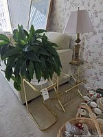 Plant stand with planter, peace lily, and table lamp in use
